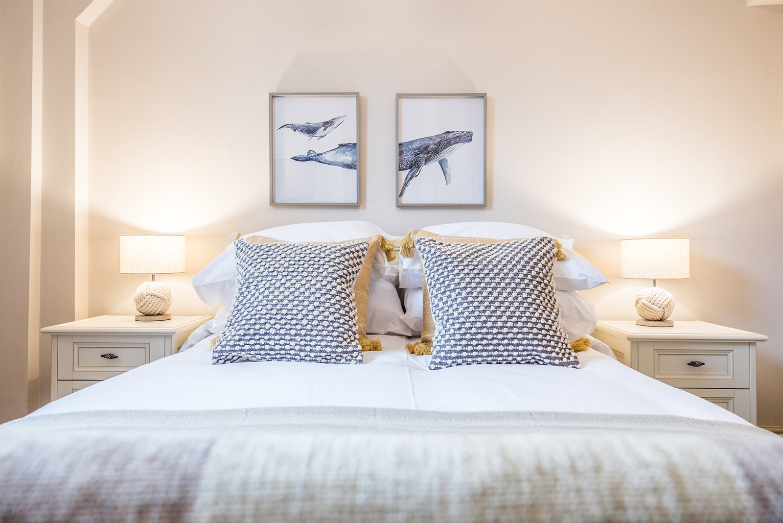Bedroom with 2 whale pictures in background